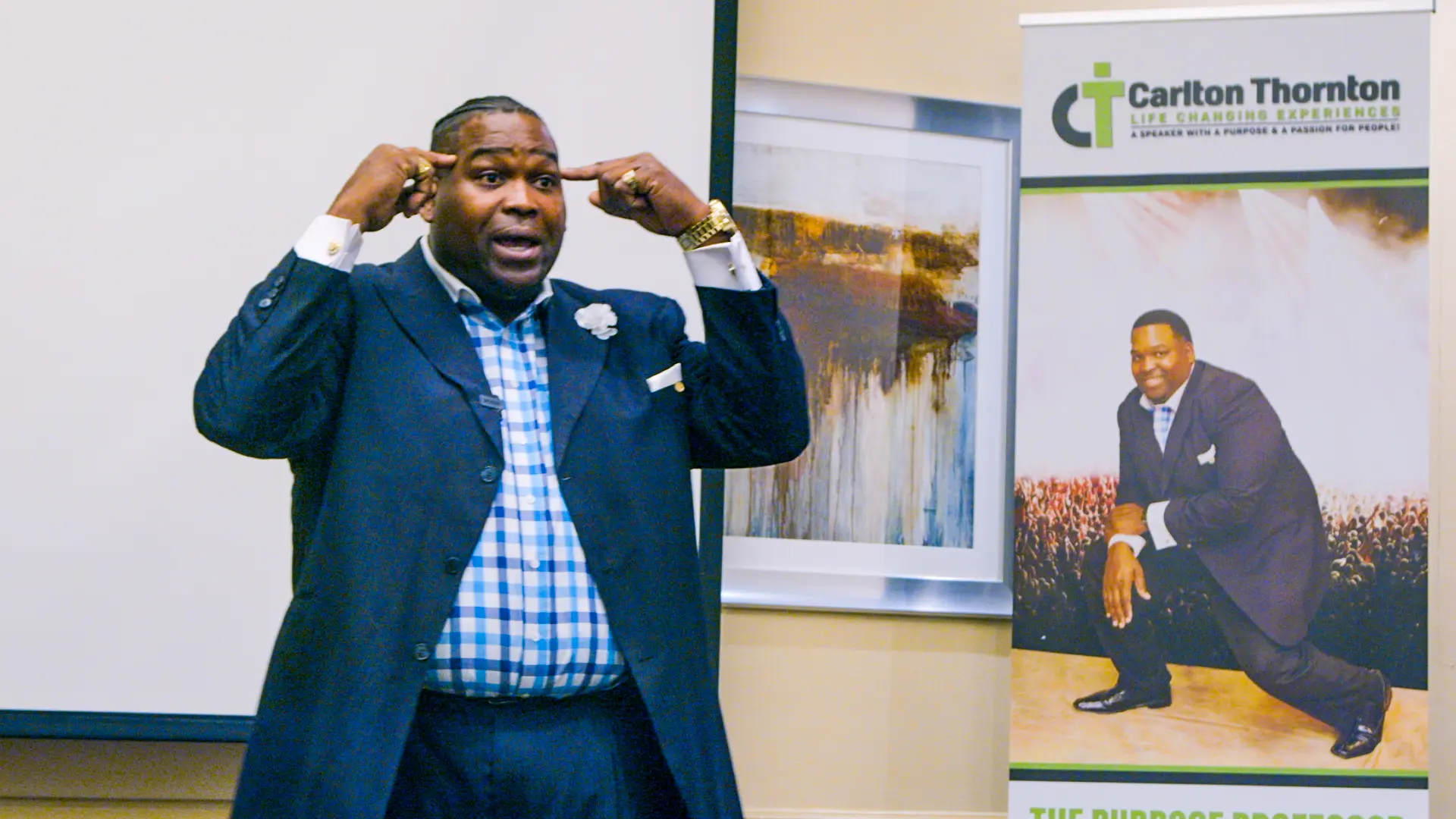 A man in a suit and tie holding his head