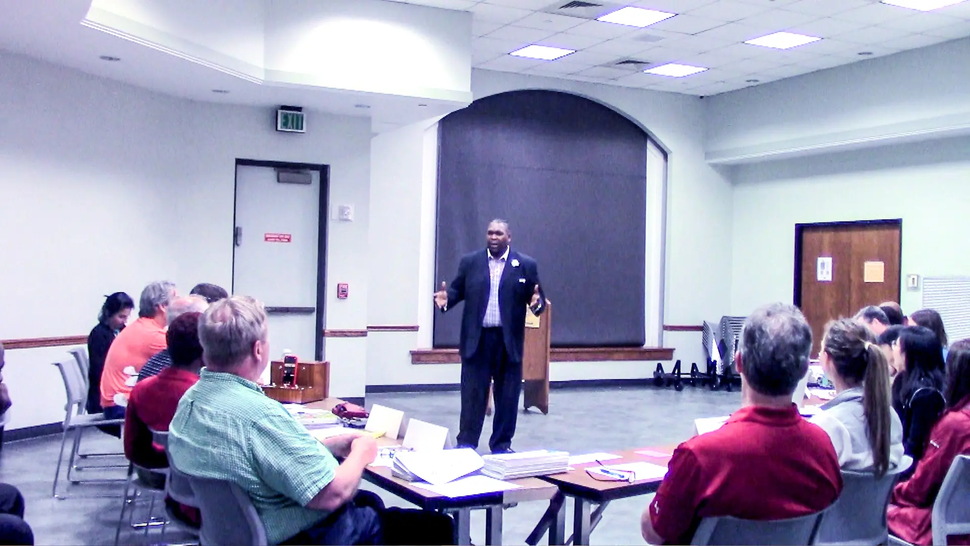 A man standing in front of several people.